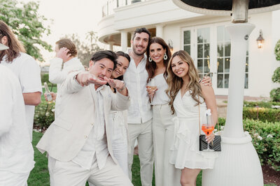 bridal party celebrates as groom kisses his bride at cielo farms wedding in malibu captured by los angeles wedding photographer magnolia west photography