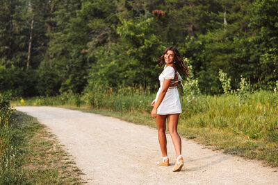 Girl smiling at the camera as she walks away - Park Rapids, Minnesota