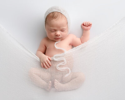 Bend Newborn Photographer, Baby tucked in white