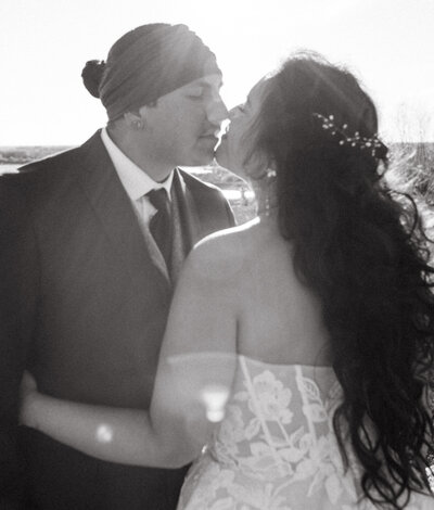 Shania and Jon embracing during their romantic candlelit wedding at The Avenue Room in Saskatoon, photographed by Kayla Cassidy Photography.