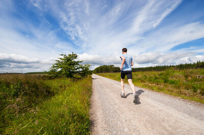 man running on dirt road
