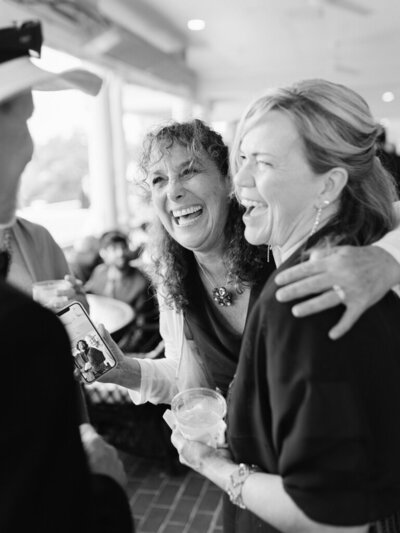 Wedding guests laughing taken by one of the top baltimore wedding photographers Nicole Simensky