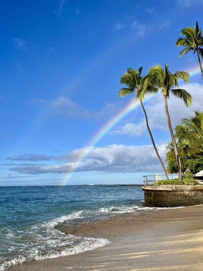 a double rainbow on seen from a beach in Hawaii