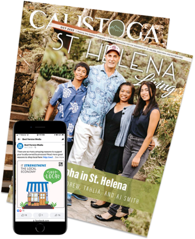 Stack of St Helena Living and Calistoga Living magazines with an iPhone displaying a digital ad.
