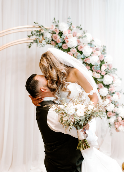 Groom Lifting Bride for a Kiss