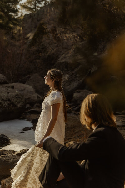 Bride and groom kissing under a rainbow captured by a Minnesota wedding and elopement photographer
