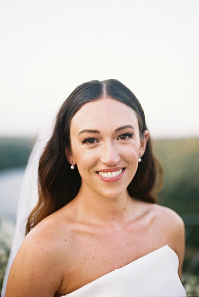Bride smiling softly during golden hour at Altos de Chavón, captured on film by Asia Pimentel Photography — timeless and natural elegance.