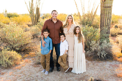 family smiling together at camera in Scottsdale family photography session
