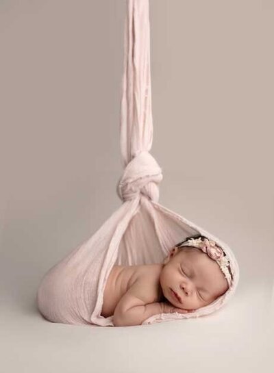 Stork pose of baby girl sleeping. Photographed by Jenni Nikki at her Woodstock photo studio near Marietta, GA.