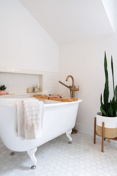 bright white bathroom with white clawfoot tub