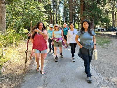Samarah Grace and women walking down path on reiki retreat