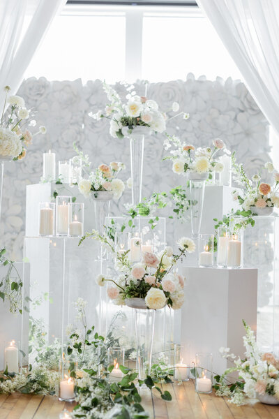 Elegant white flowers and candles adorn the venue, creating a romantic and timeless ambiance.