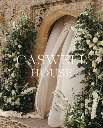Luxury brand design for Cotswolds, England, UK wedding venue estate white logo over photo of event décor