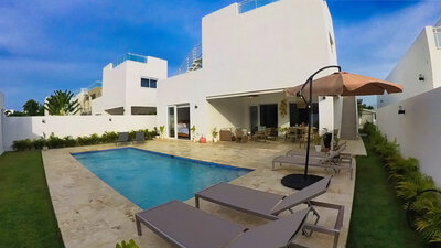 Lounge chairs beside a private pool at a modern villa by Nova Lux DR Properties