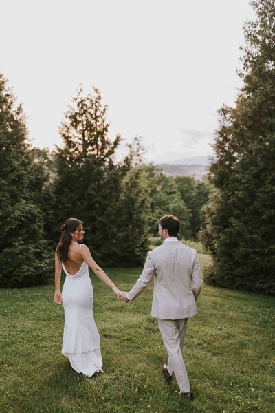 couple exchanged rings while groom is behind bride