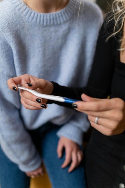 A couple are looking at a pregnancy test after going through IUI