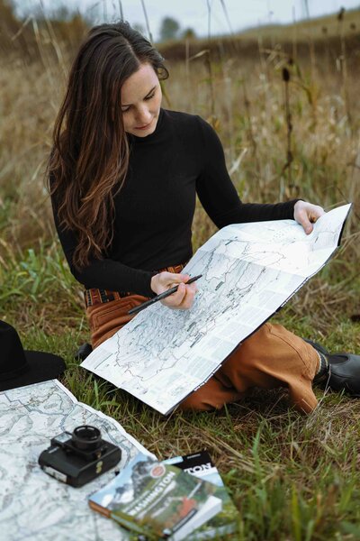 a woman holds a map marking out an itinerary
