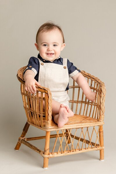 Baby sitting in chair for first birthday photography session in Ann Marshall's Portland Studio