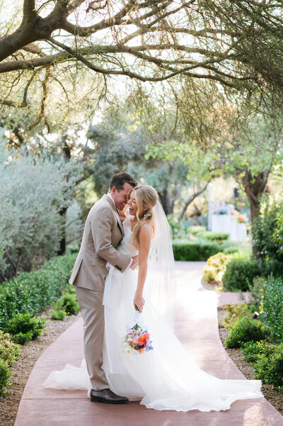 Bride and groom sharing a joyful embrace during their El Chorro wedding in Scottsdale, Arizona.