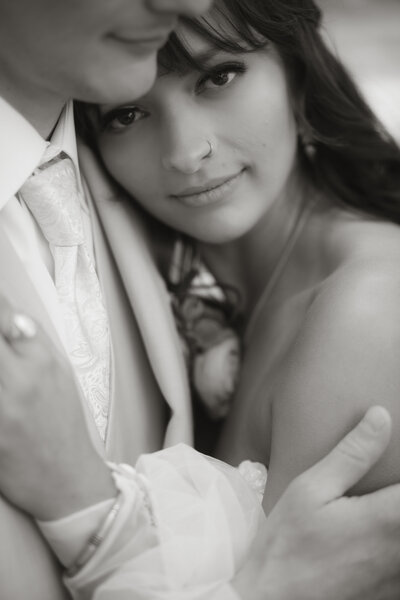 Black and white close-up of Madison resting against Ben during their wedding at The Paddock, captured in an emotive and romantic style.