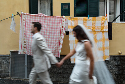 Bride and groom standing in front of beach house