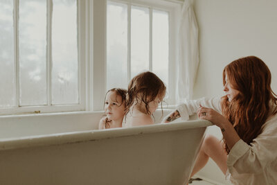 mom gives her two babies a bath