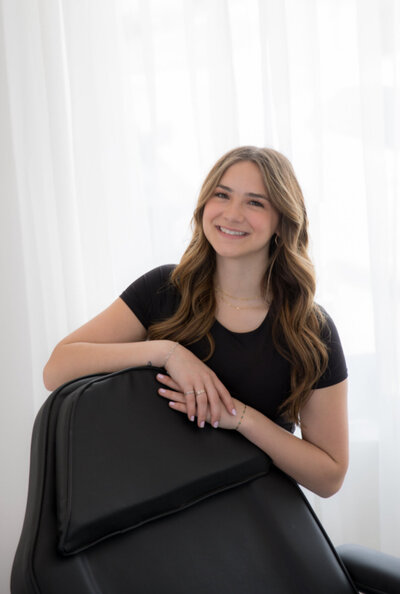 Addyson, a stylist at Tailored + Co, specializing in natural hair color, radiant facials, and bridal glam services in Watertown, SD.