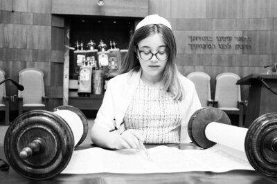Black and white photo of Charlotte reading torah
