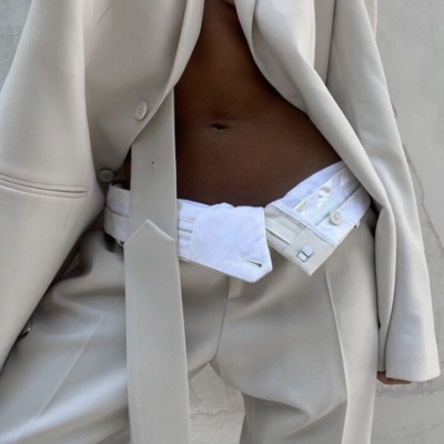 Casual and modern lawyer wearing white outfit with gold accessories