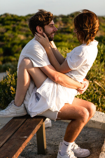 Couple seperating in the moments after a piggyback ride, wife's arm still around husbands chest and both laughing