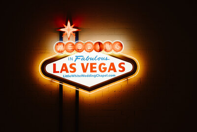 A photo of the Las Vegas sign at The Little White Wedding Chapel in Las Vegas at night.