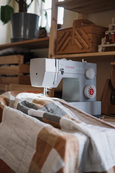 A Singer sewing machine and quilt in progress in Kassia Karr's studio In London