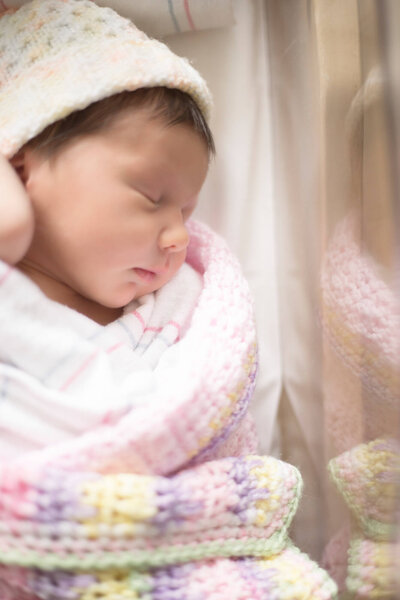 sleeping newborn baby girl profile while laying down