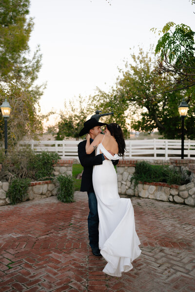 groom spinning the bride around during their wedding portraits