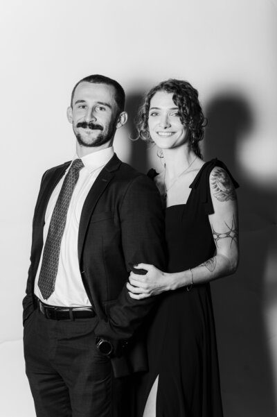 Elegant black and white portrait of a smiling couple dressed in formal attire at a Vogue Portrait photo booth in Richmond, VA.