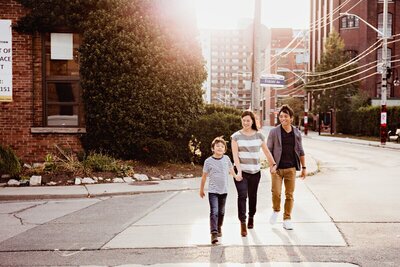 Family of 3 walking across street