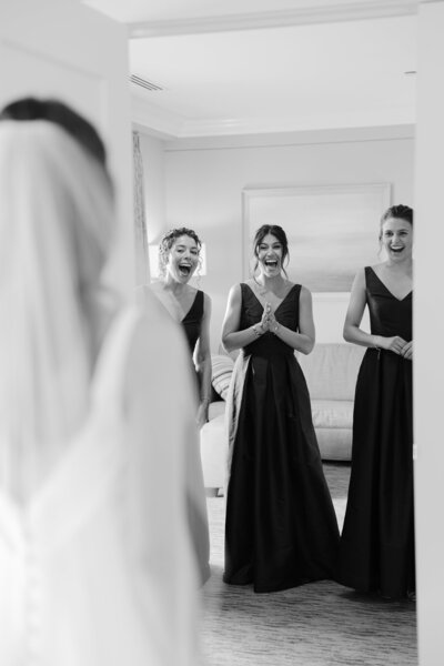 Bride dress reveal with bridesmaids who have a big smile