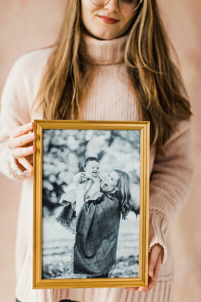gold frame with black and white portrait of mother and daughter