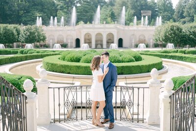 portrait of a couple at the DuPont estate with water fountains in the background