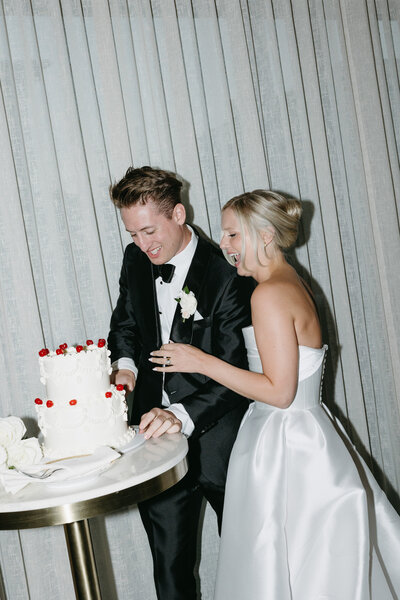 Bride and groom cutting a beautifully styled vintage wedding cake, captured by a Wisconsin wedding photographer.