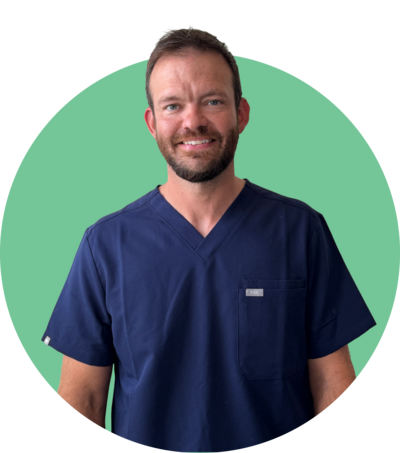headshot of surgeon in blue scrubs