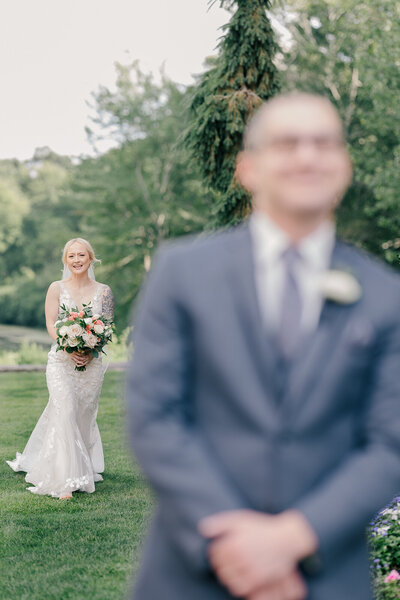 ethereal bridal portrait of woman holding bouquet and walking in the wind