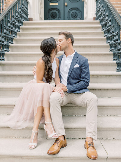 bride and groom kissing on steps on jones street in downtown savannah