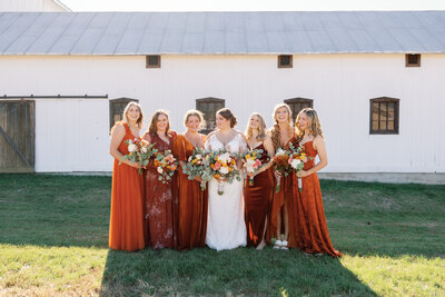 A fall inspired October wedding with bridesmaids wearing burnt orange bridesmaid dresses