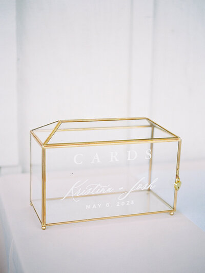 A golden wedding card box with intricate designs and a shiny finish. Perfect for storing cards on a special day.