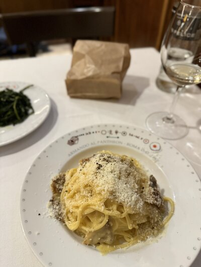 Authentic pasta dish being served at a traditional trattoria in Rome