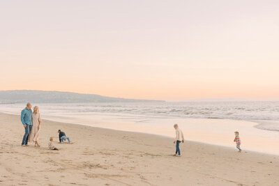 children playing on the beach in california on a slow and quiet morning