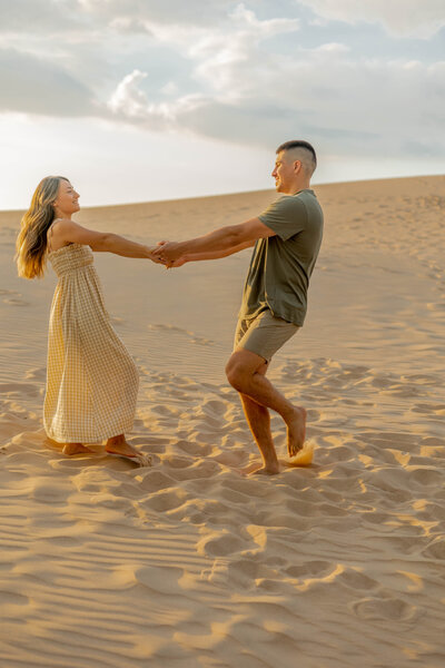 couple at sand dunes engagement session