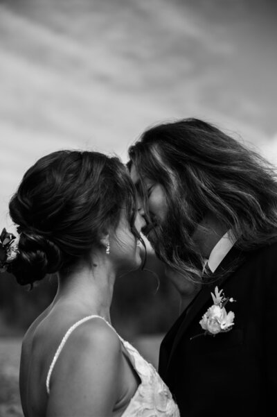Romantic black and white wedding portrait of a couple sharing an intimate moment, capturing timeless emotion and connection in an elegant and artistic photography style by a Portland and destination wedding photographer.