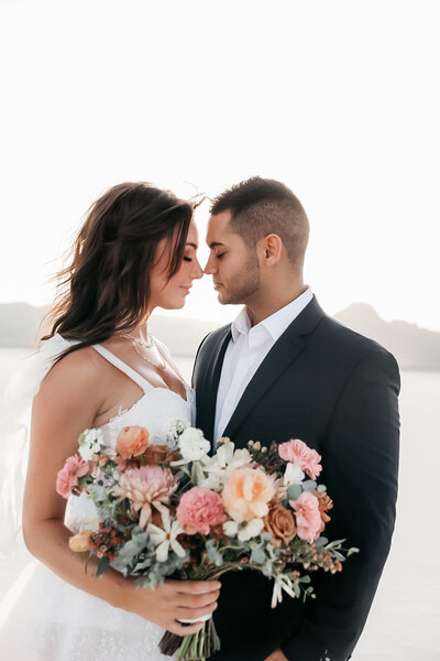 Couple bridal shoot photos at the Utah Salt Flats with bouquet.